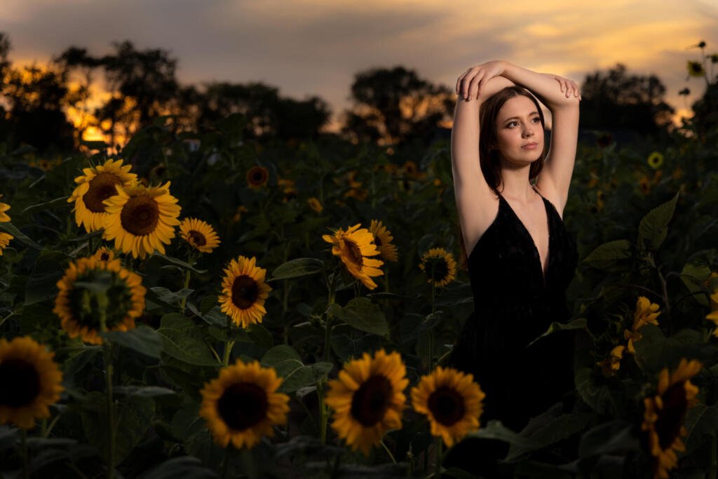 Senior photo of girl in sunflower field